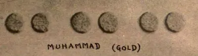 Three pairs of tiny round gold coins photographed against a grey ground, labelled "Muhammad (Gold)".