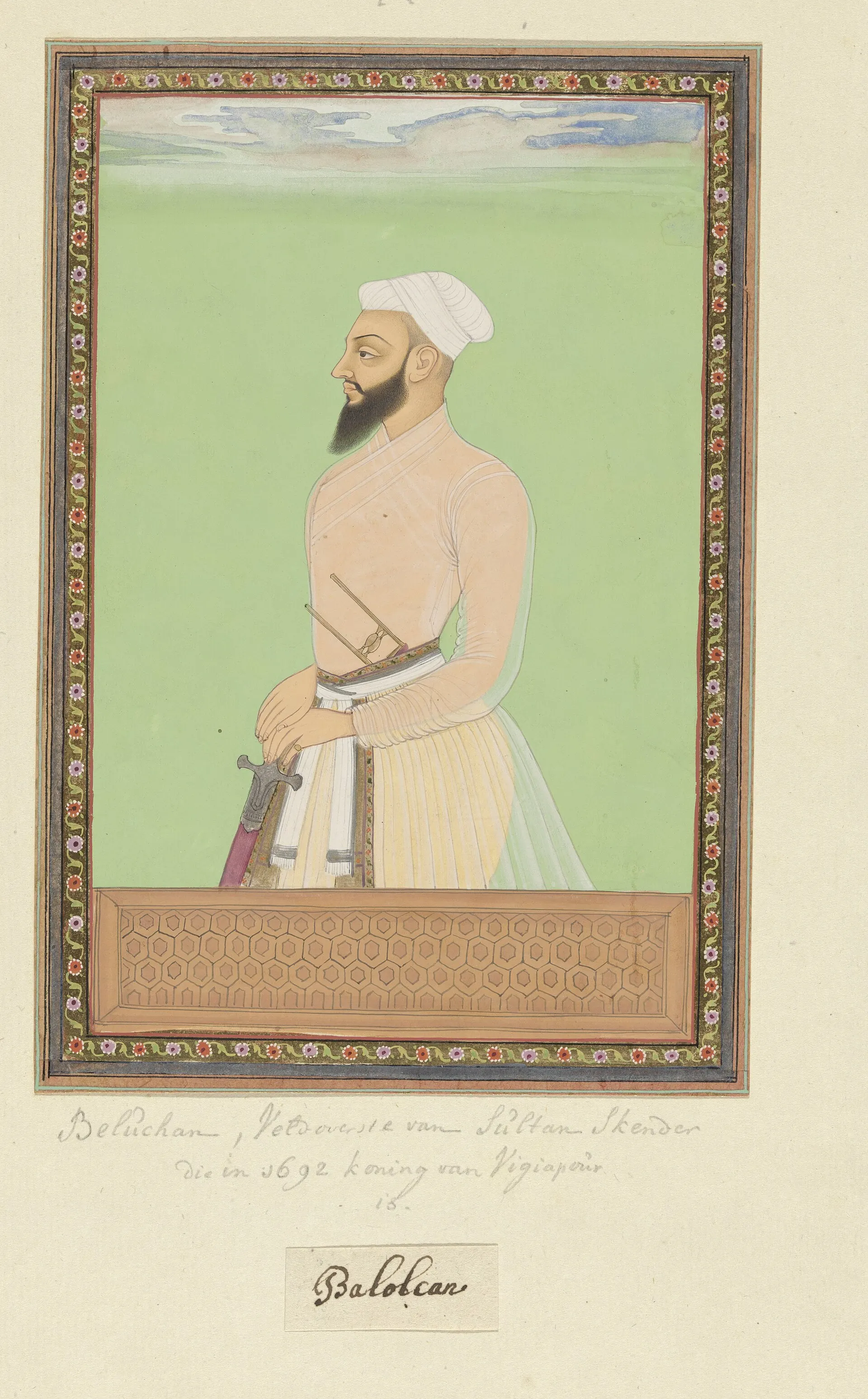 Deccani painting of a bearded noble in a pale jama and white turban with a sword at his waist, standing against a green ground within a decorated border.