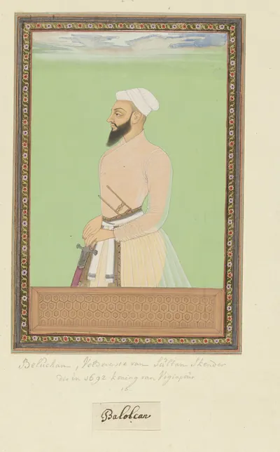 Deccani painting of a bearded noble in a pale jama and white turban with a sword at his waist, standing against a green ground within a decorated border.