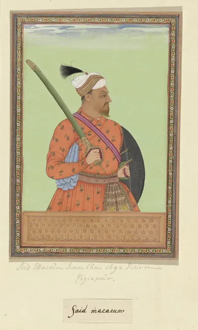 Deccani painting of a dark-bearded warrior in a red patterned coat with a sword over his shoulder and a round shield, standing against a green ground within a decorated border.