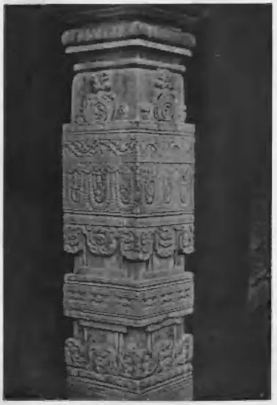 Old photograph of a square stone pillar carved with bands of floral and figure ornament.
