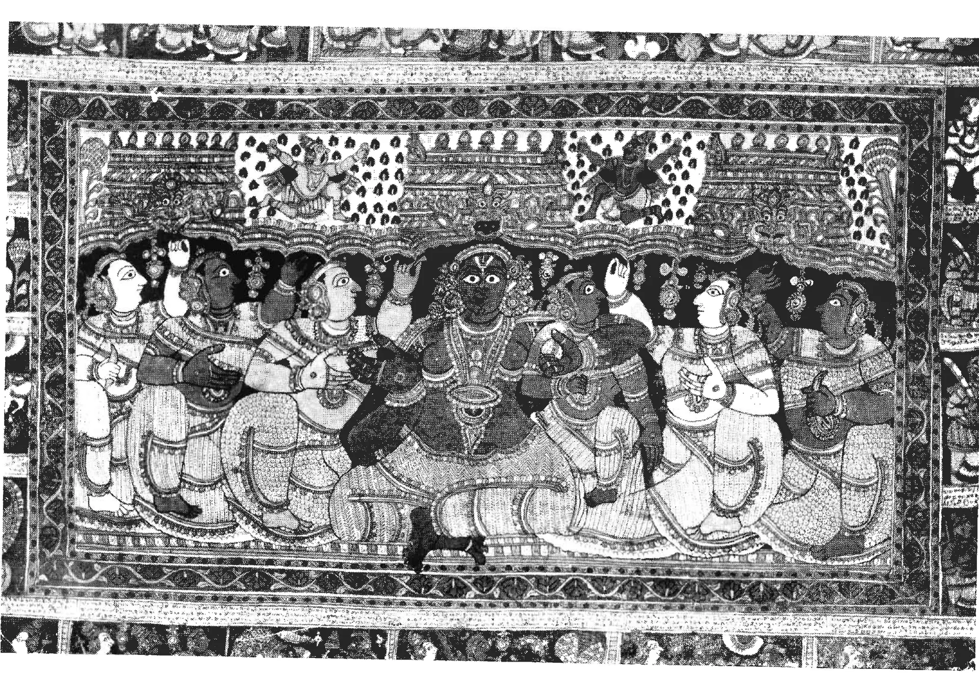 Black-and-white photograph of a painted cloth: a dark-skinned Krishna sits in the centre among women, under a row of arches, with a border of small scenes all round.