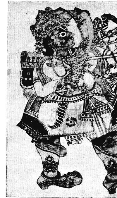 Black-and-white photograph of a large leather puppet of a crowned figure drawing a bow, with patterned clothes and jointed legs.