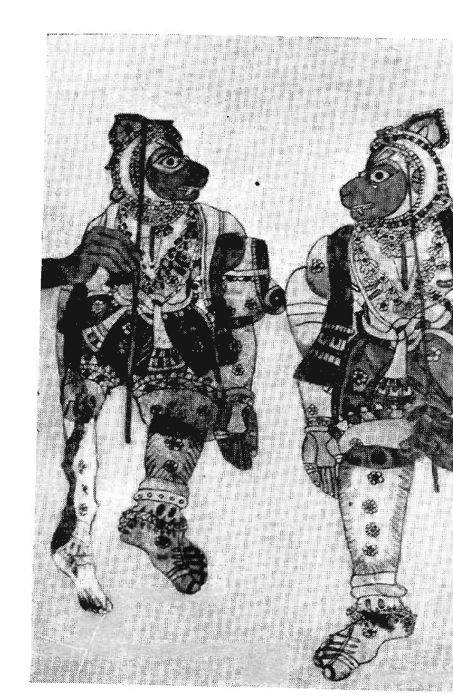 Black-and-white photograph of two leather puppets of monkey-faced warriors in patterned clothes, standing side by side.