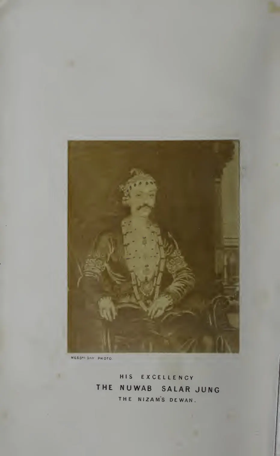 Mounted sepia photograph of Salar Jung seated, in rich dress and turban.