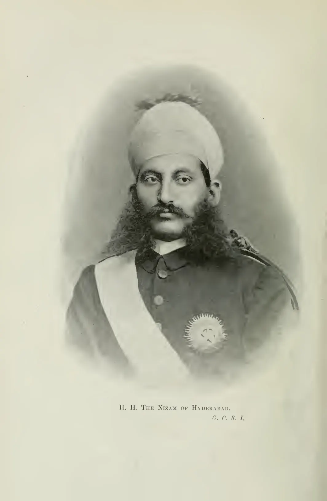 Portrait photograph of the Nizam of Hyderabad in a turban and uniform with a sash and star.