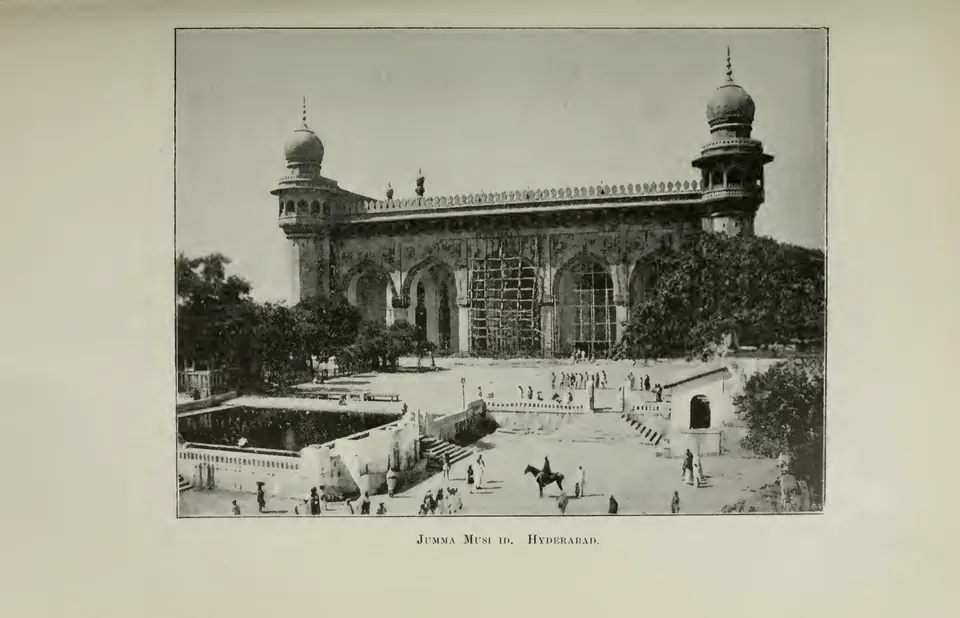 Photograph of the front of a mosque in Hyderabad with a minaret, arches and a courtyard. Printed sideways.