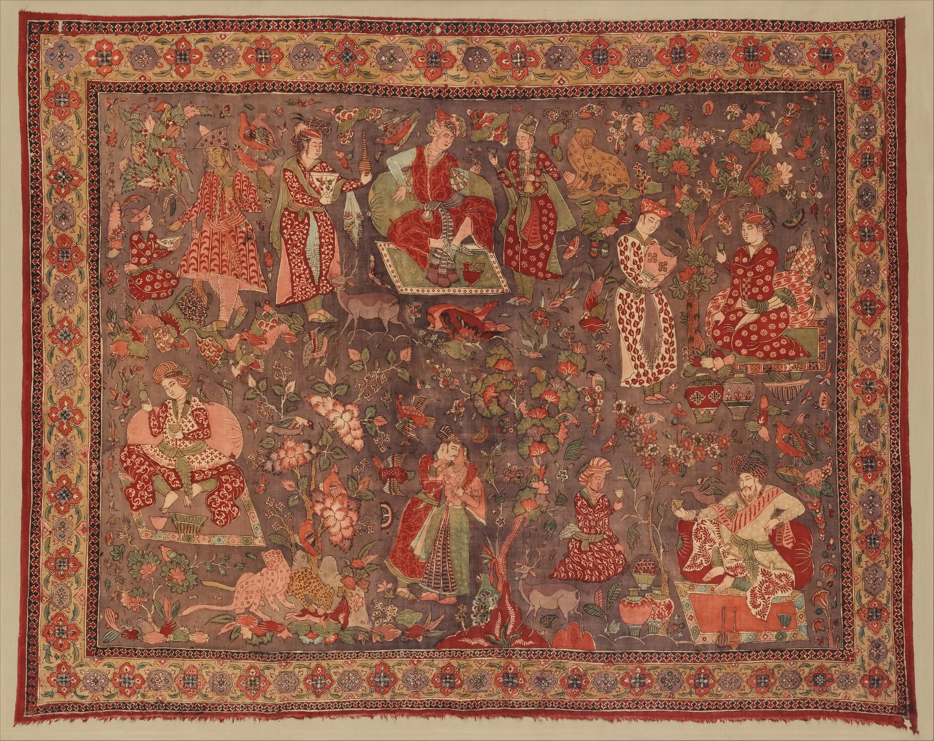 17th-century painted and dyed cotton kalamkari cover from Golconda, showing courtly figures in a red-bordered field.