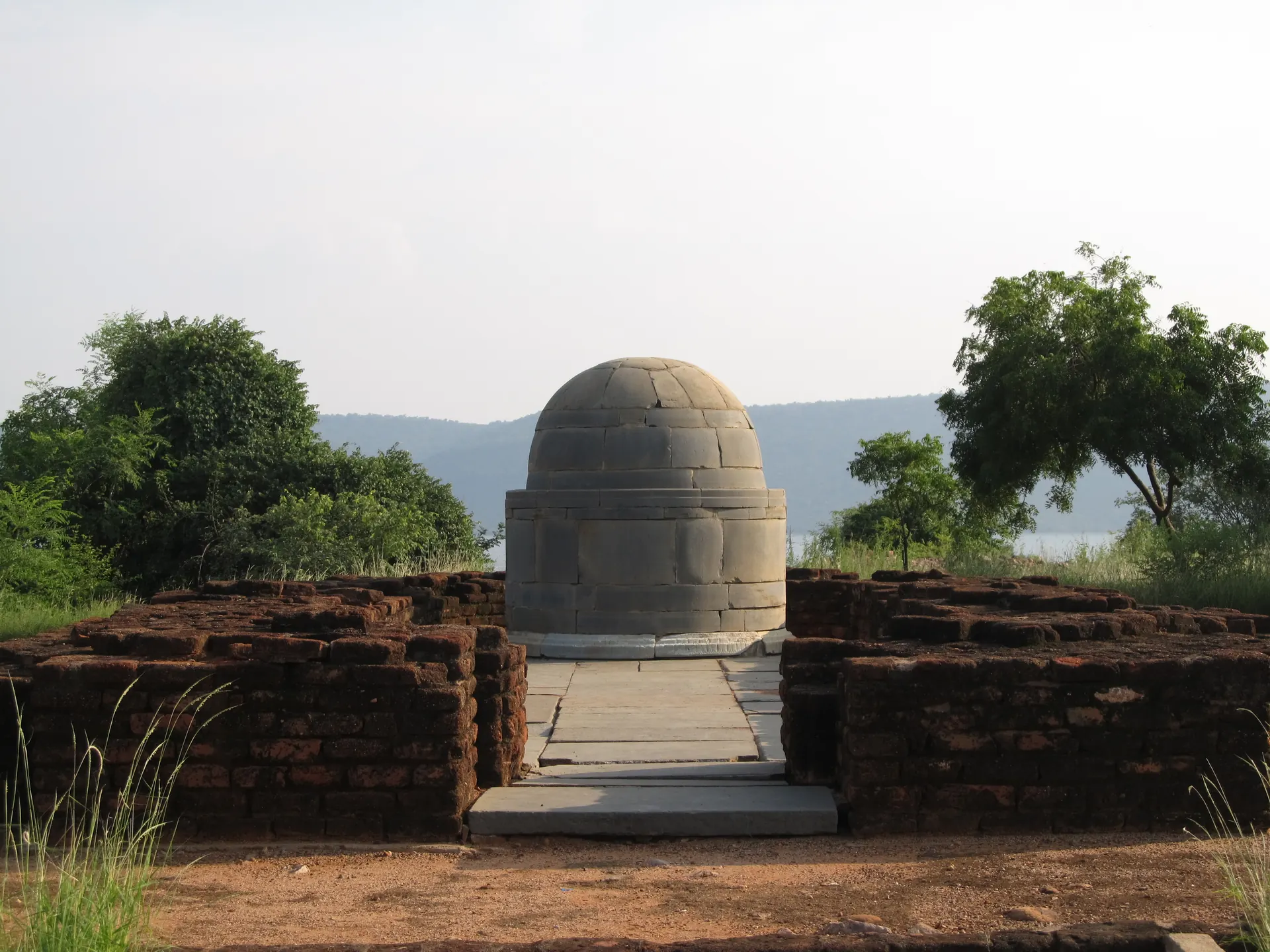 The rebuilt Bodhisri chaitya at Nagarjunakonda, a small domed stupa inside a brick apsidal shrine.