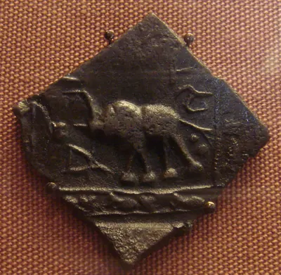 Square copper Satavahana coin of the 1st century BCE showing an elephant and a Brahmi legend.
