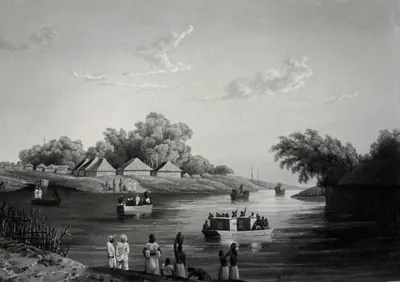 Grey engraved view across a wide river to a low bank lined with trees and houses with pyramid roofs, with small boats and a covered barge on the water and people standing on the near shore.