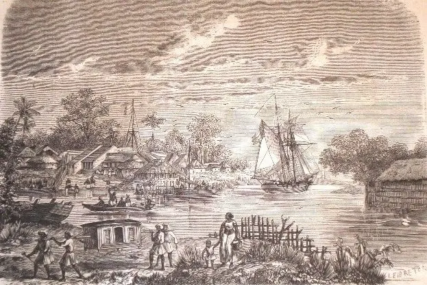Wood engraving of a riverside town with tiled and thatched houses among palm trees, a two-masted ship and small boats on the river, and people walking past a fence on the near bank.