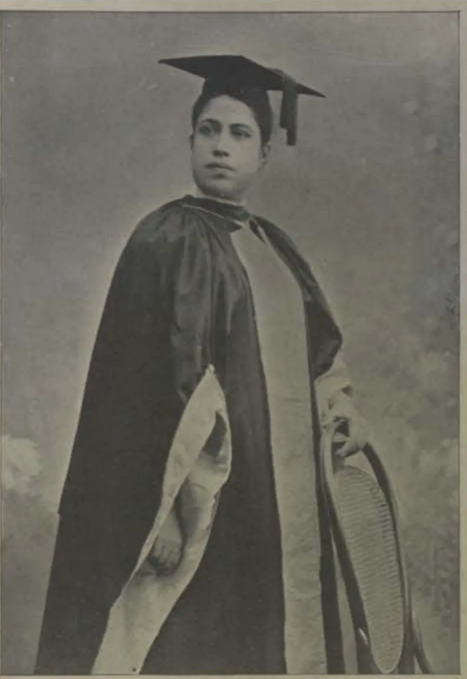 Dr Edith Boardman standing in an academic gown and mortarboard.