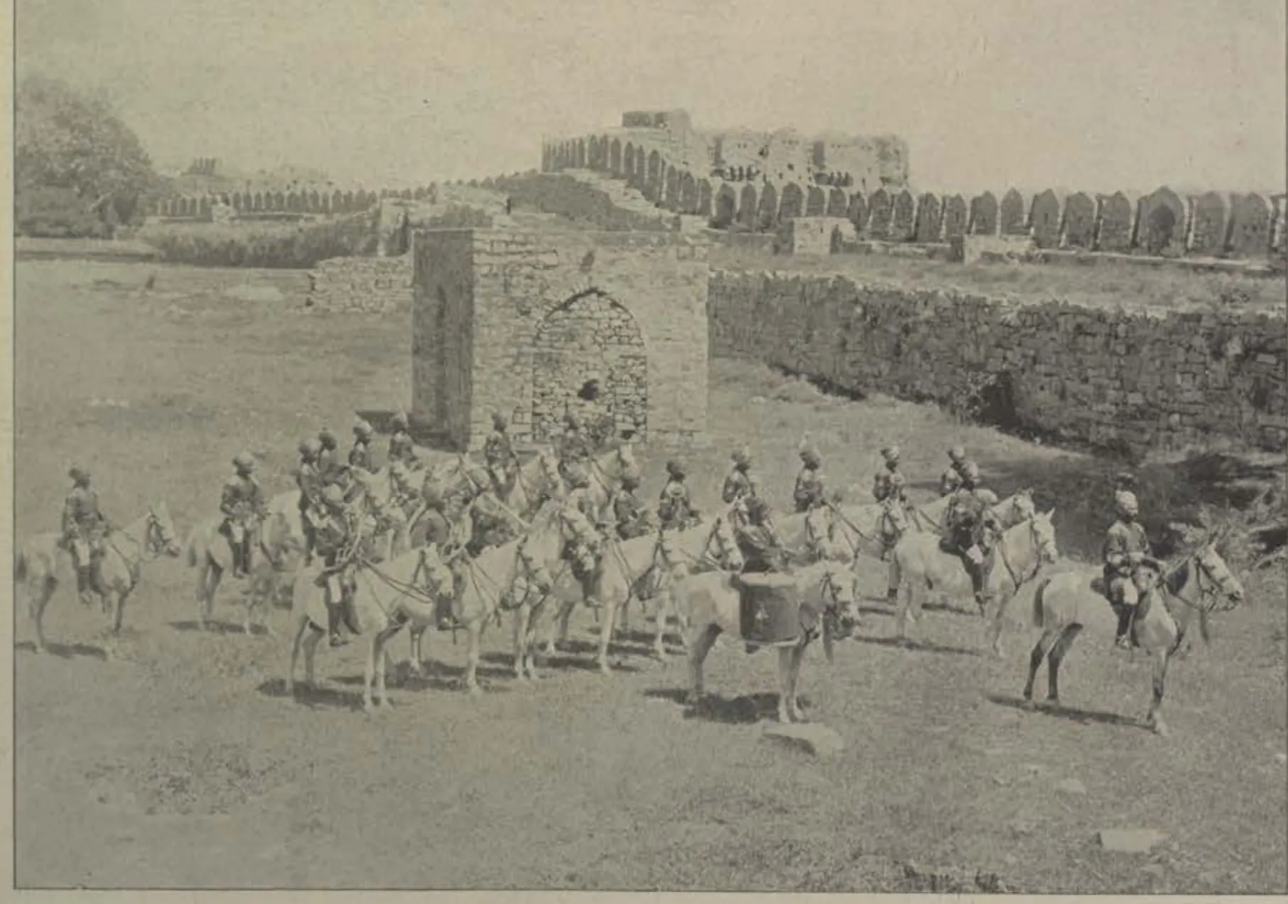 The mounted band of the Golconda Lancers riding in front of old walls.