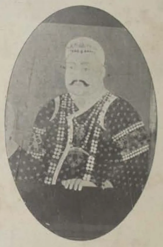 Oval photograph of a painted half-length portrait of an earlier Nizam in a jewelled turban and necklaces.