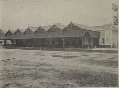 The Hyderabad railway station, a long train shed with a row of gabled roofs beside the tracks.