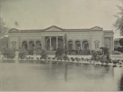 The guest house of the Salar Jung palace, a classical building seen across a sheet of water.