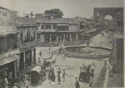 The Gulzar Hauz, a fountain basin in a square, with buildings, people and carriages around it.