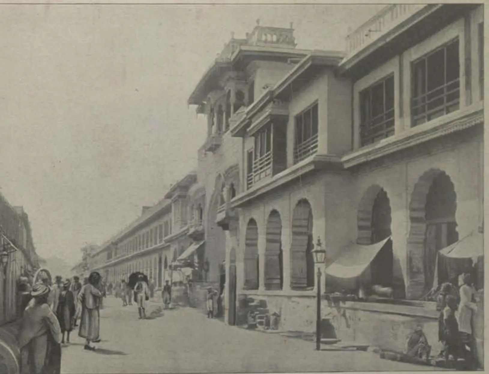 A street lined with tall arcaded buildings.