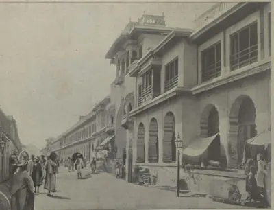 A street lined with tall arcaded buildings.