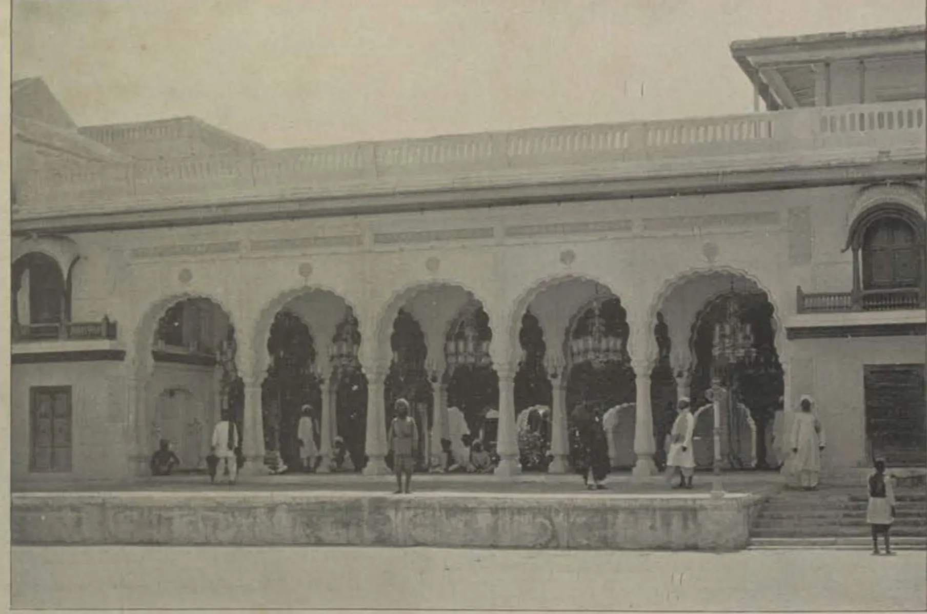 A palace front with an arcade of cusped arches.