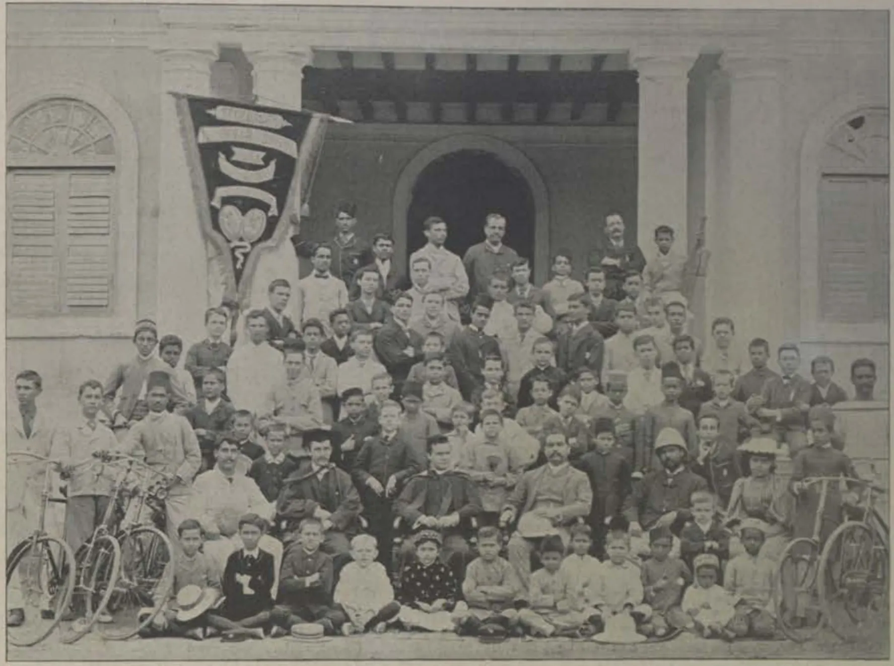 The pupils of St. George's Grammar School in rows in front of the school building.