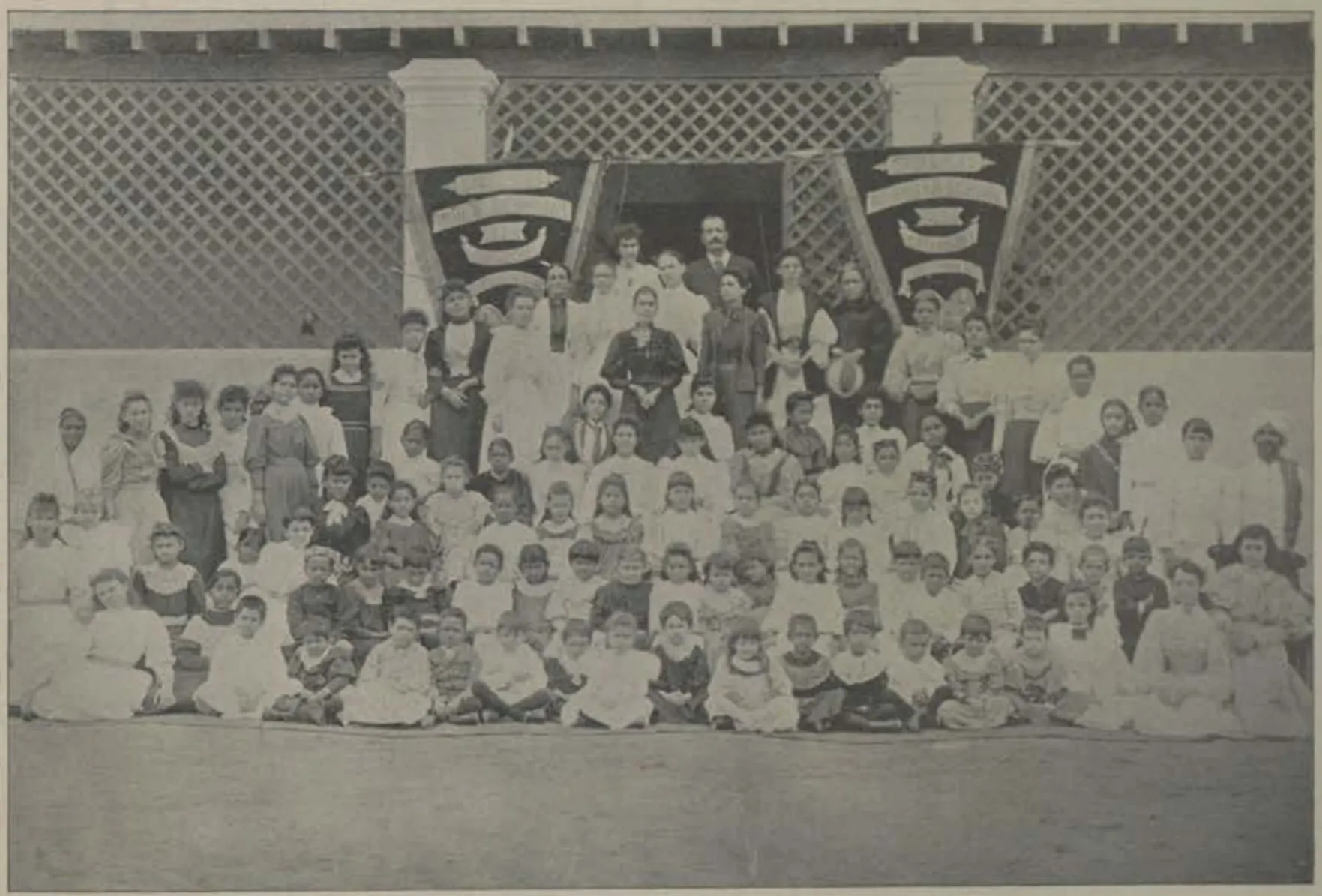 The girls of St. George's Girls' Seminary in rows in front of the building.