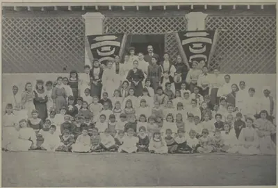 The girls of St. George's Girls' Seminary in rows in front of the building.