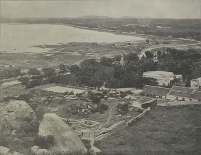 The Hussain Sagar lake seen from the Black Rocks, with rocks in the foreground.