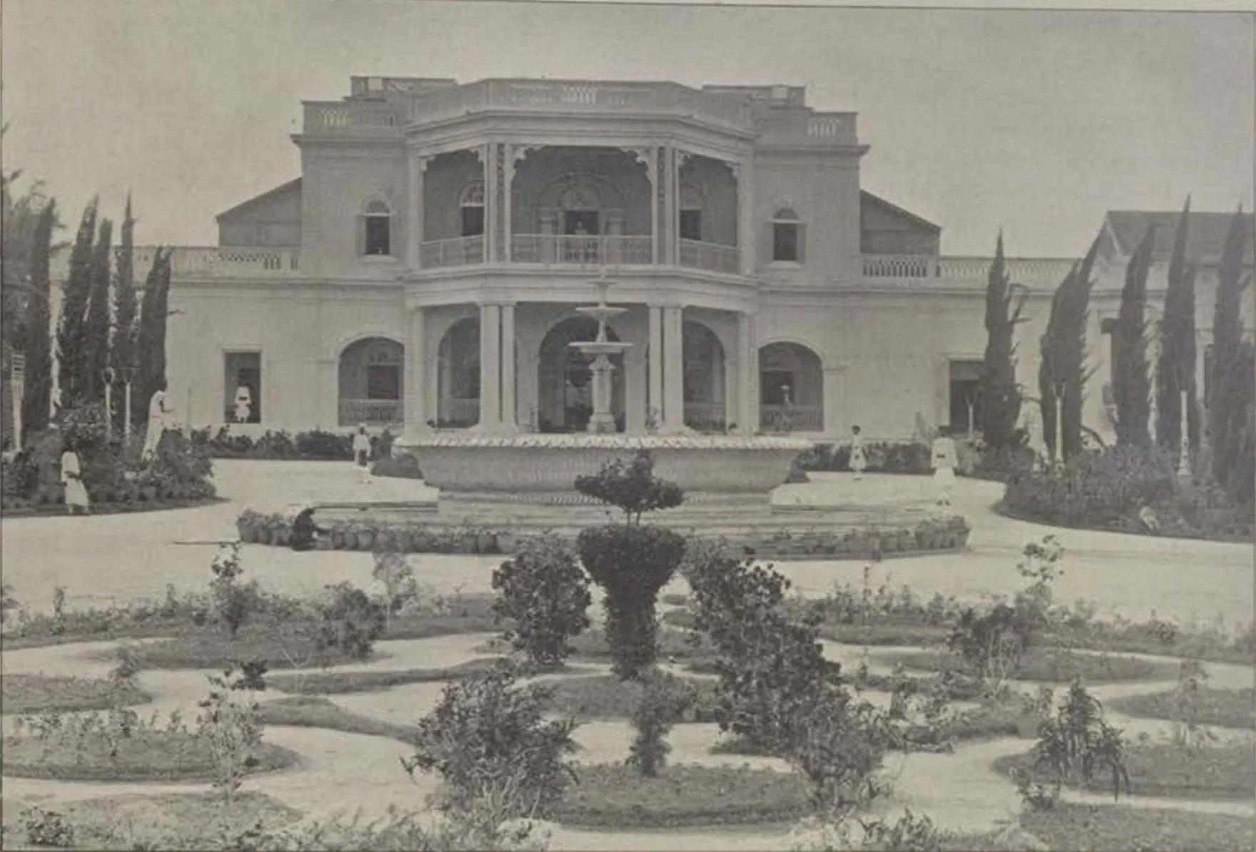 The Bashir Bagh palace, with a fountain and a formal garden in front.