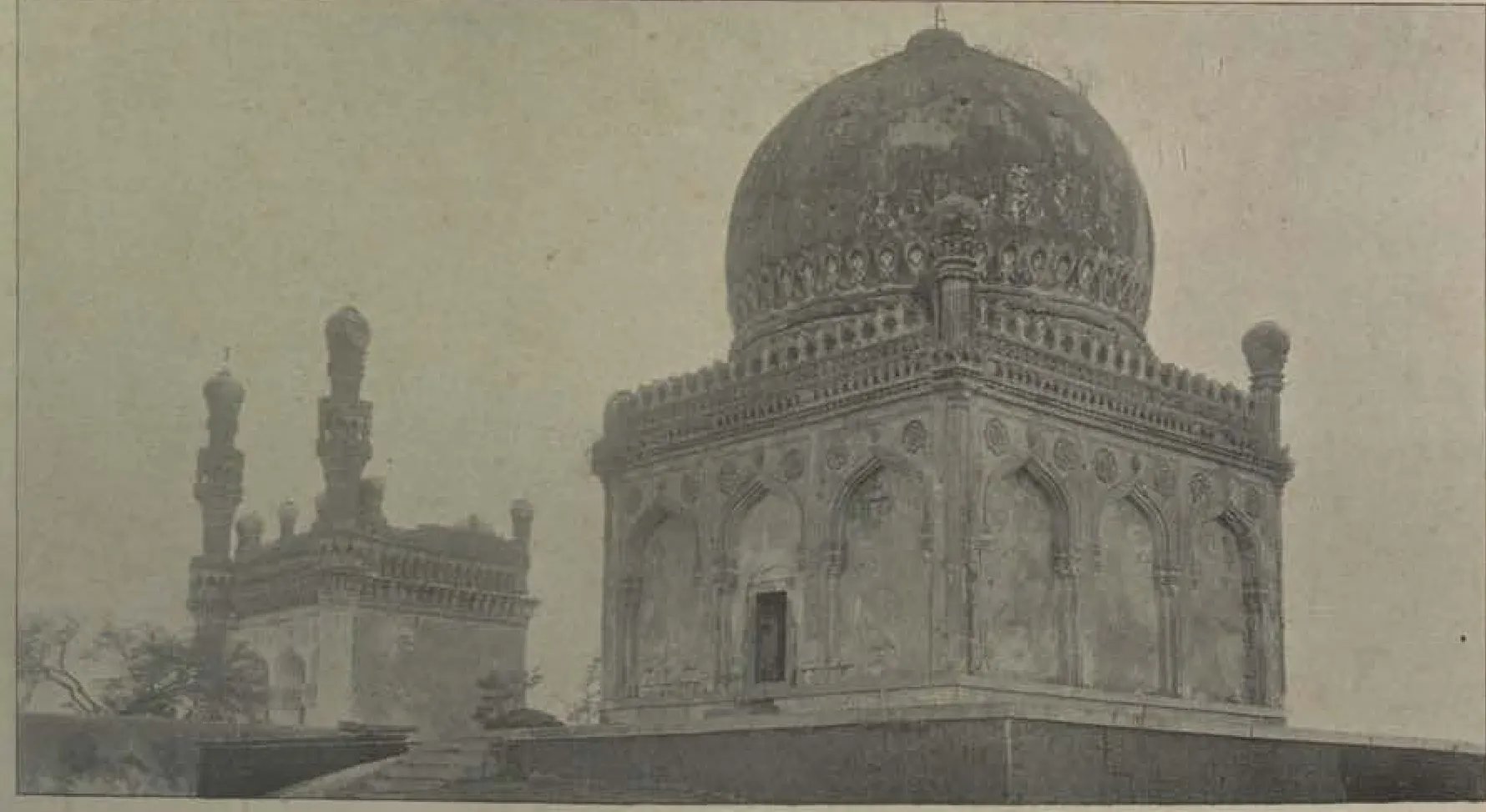 The tomb of Khairatbai, a domed tomb, with a mosque with minarets beside it.