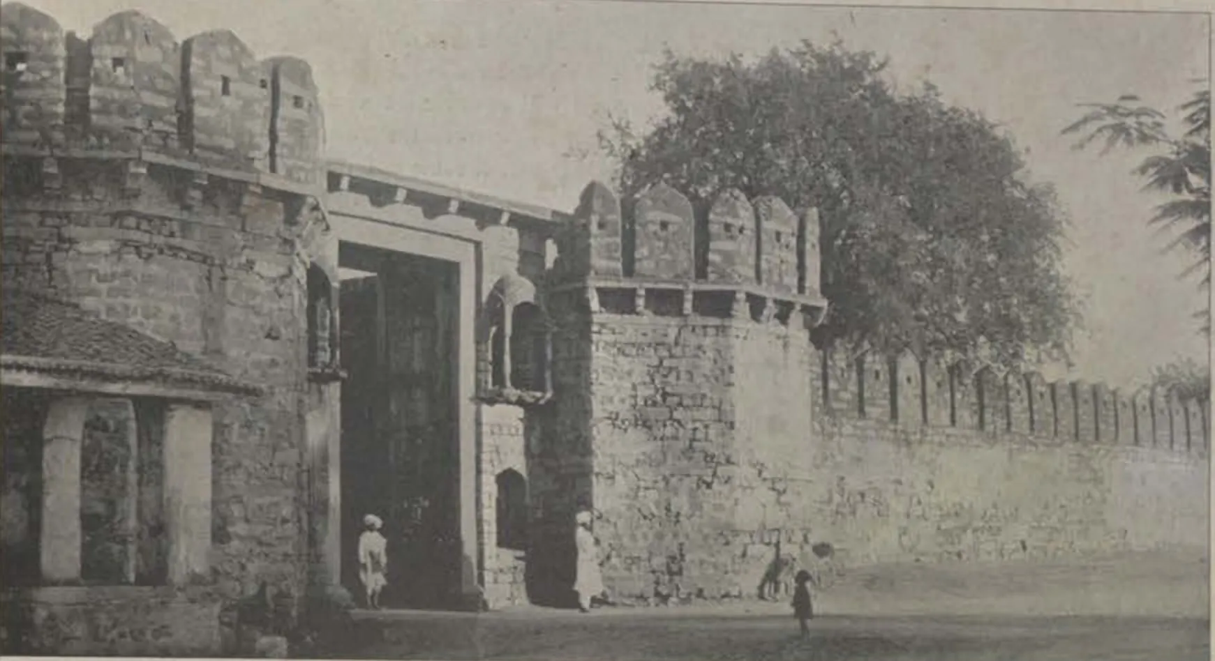 A gateway in crenellated walls at Asafnagar, with a tree.