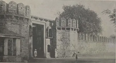 A gateway in crenellated walls at Asafnagar, with a tree.