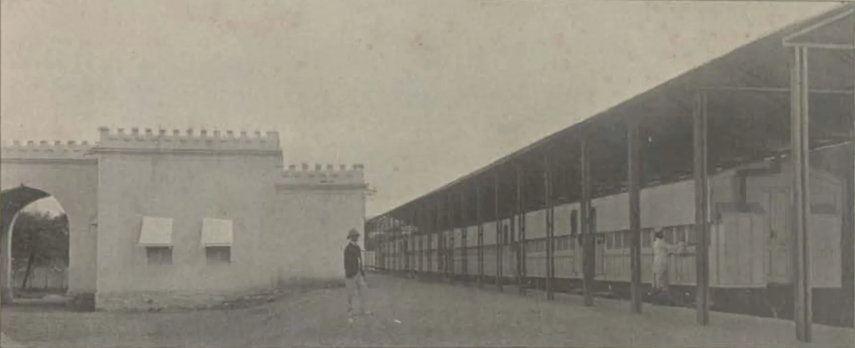The Nizam's private railway station, a long roofed platform beside a wall.