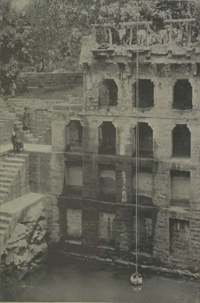 A deep stepped well with tiers of arched galleries.
