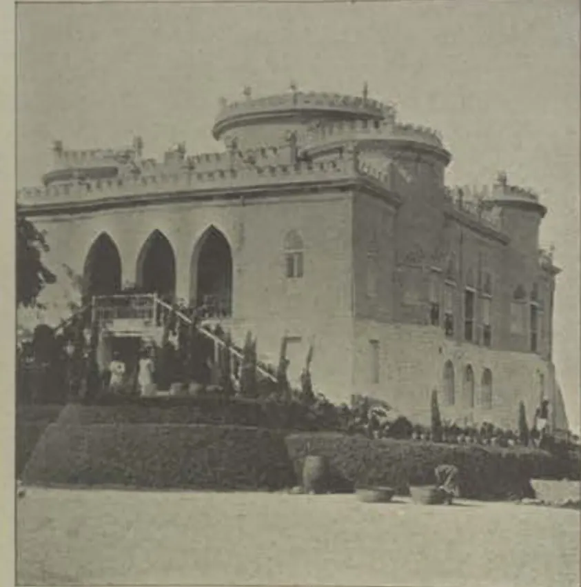 Asman Ghar, a castellated building with pointed arches, above terraced ground.