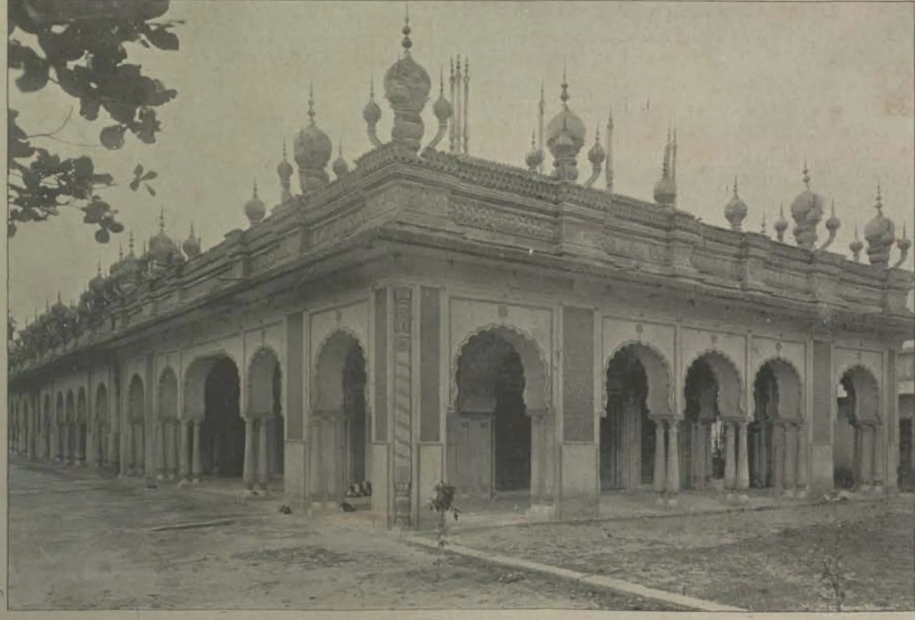 An arcaded building with many small domes and pinnacles on its roof.