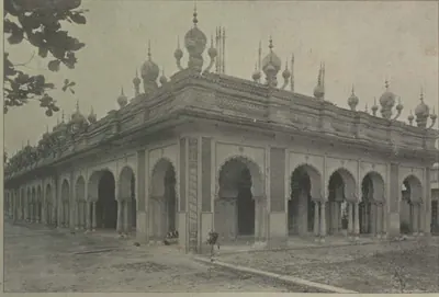 An arcaded building with many small domes and pinnacles on its roof.