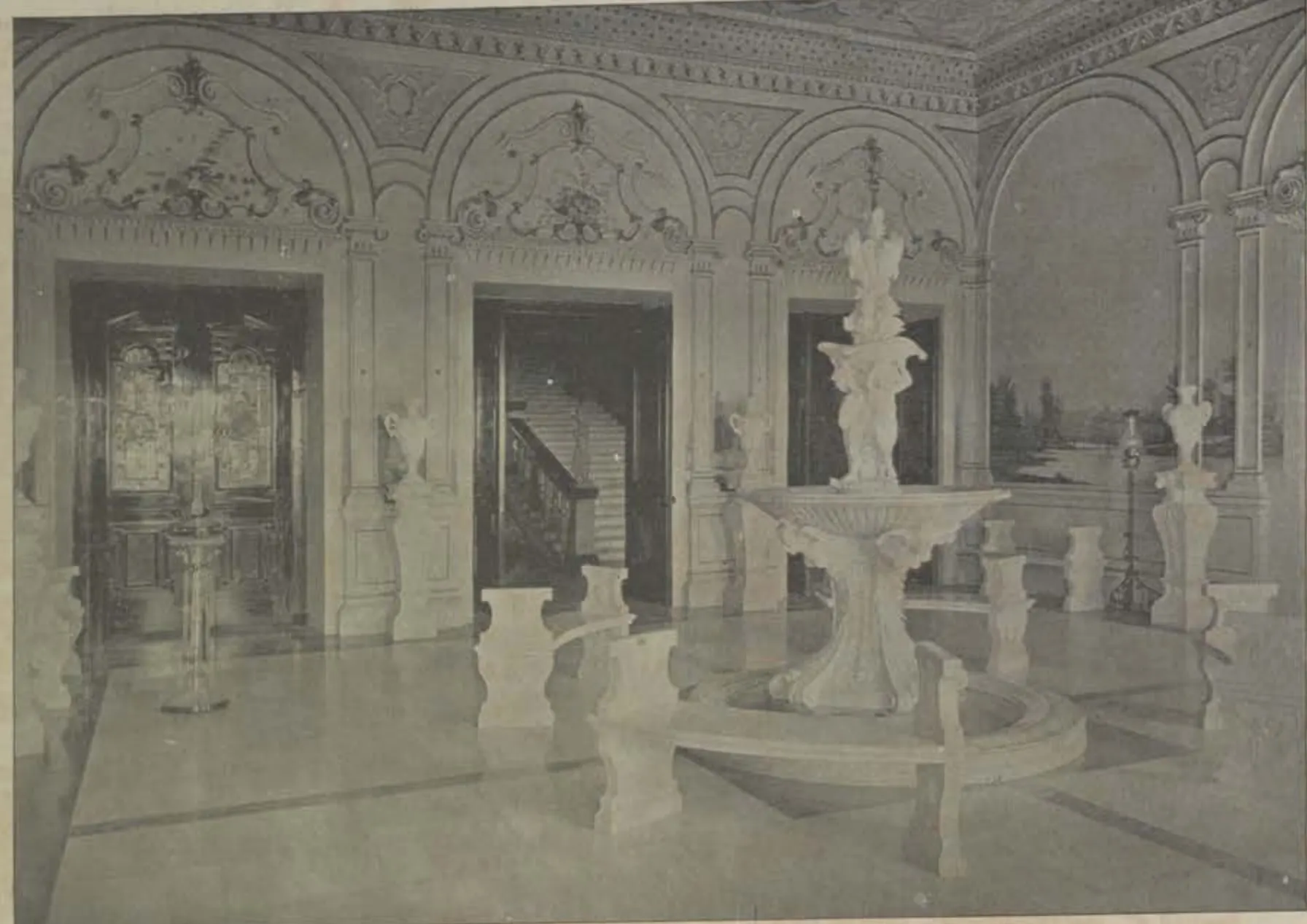 The vestibule of the Falaknuma palace, a marble hall with a fountain and statues.