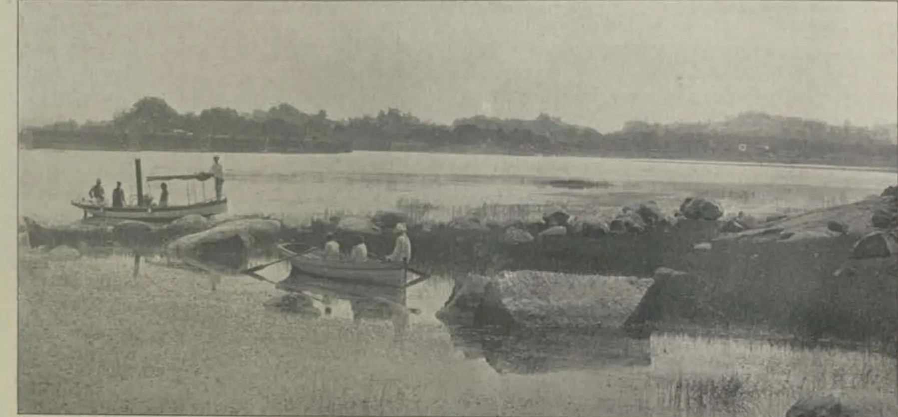 The Mir Alam lake, with boats and rocks in the water.