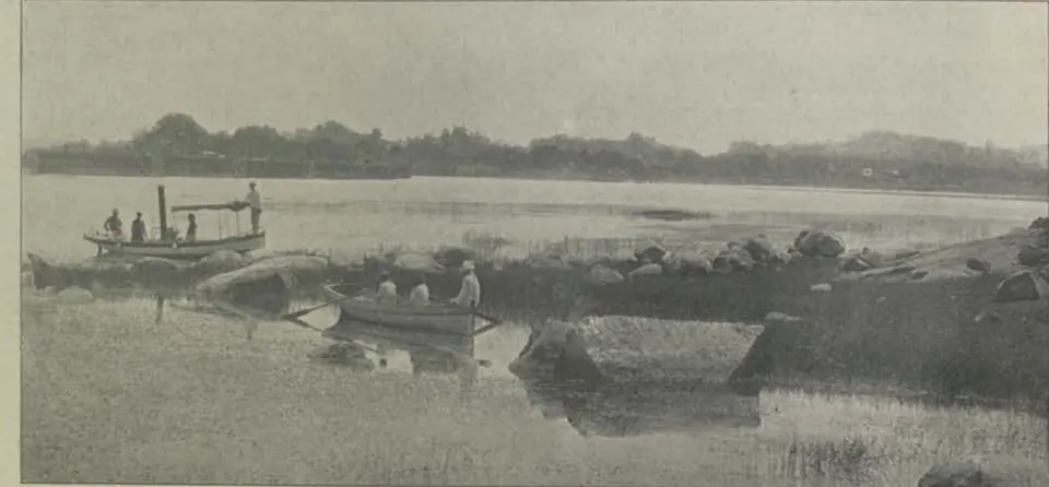 The Mir Alam lake, with boats and rocks in the water.
