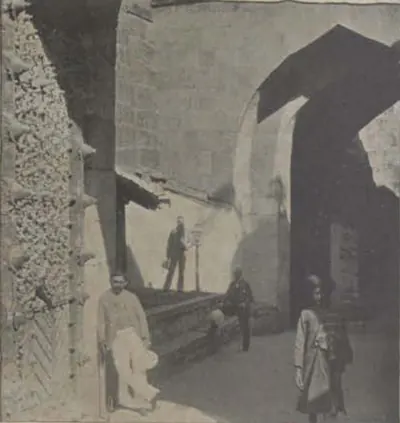 The Fateh Gate, an arched passage with men standing in it.