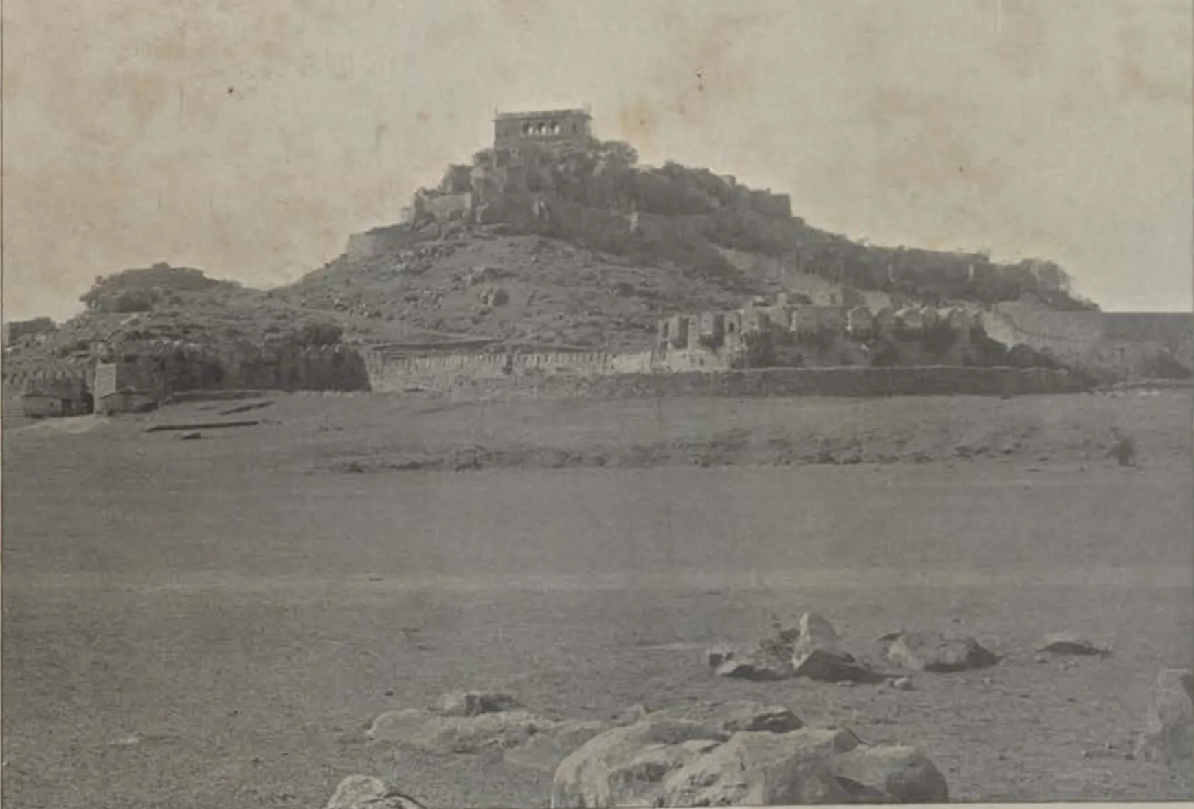 The citadel of Golconda on its hill, seen across an open plain.