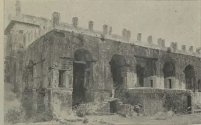 Ruins of the king's palace, a long arcaded building with a crenellated top.