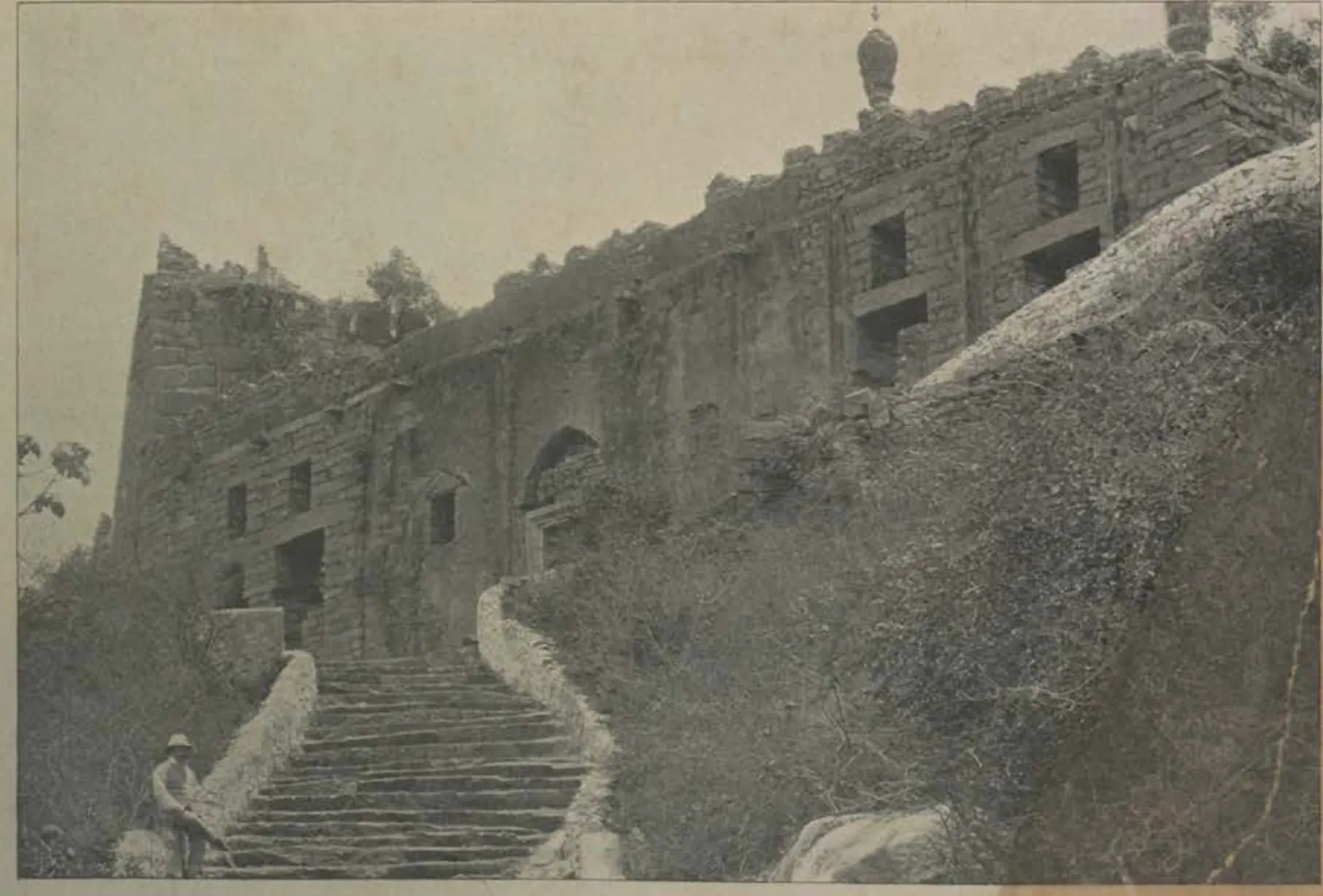 A stone stairway climbing the rock beside walls, the approach to the Ambar Khana.
