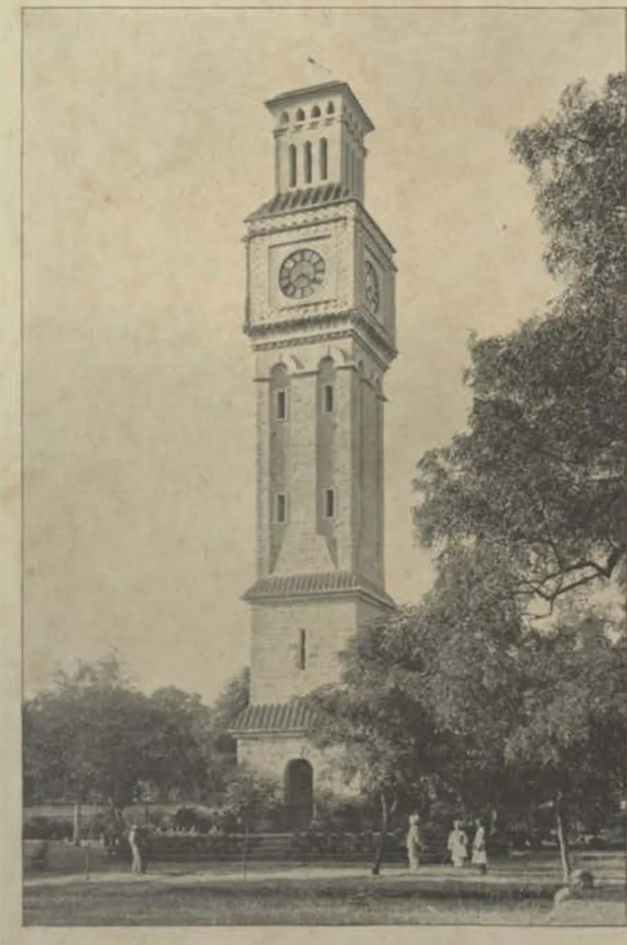 The clock tower at Secunderabad, a tall tower with a clock face, among trees.
