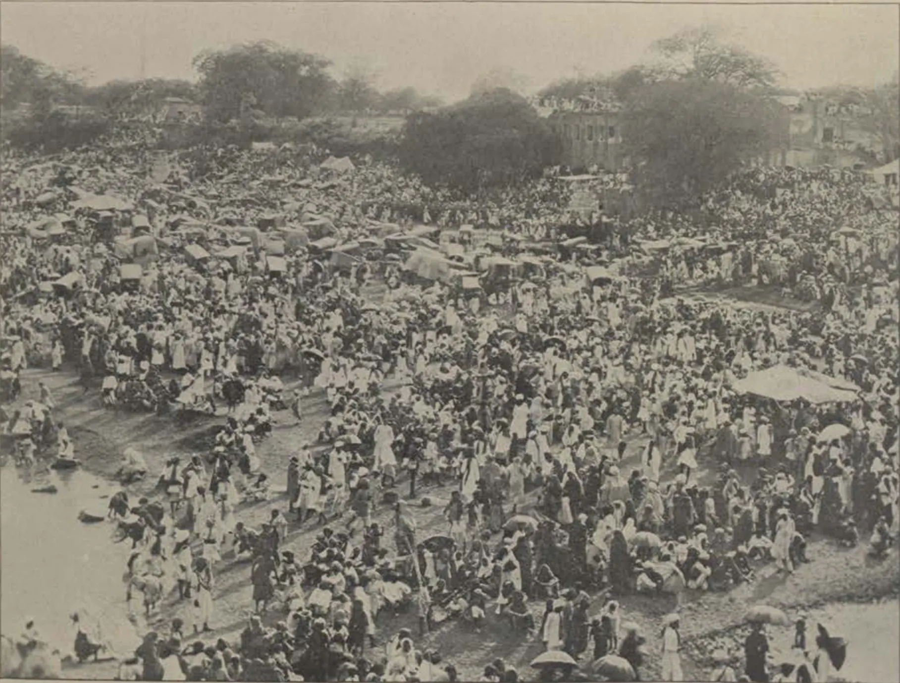 An enormous crowd filling an open ground during Muharram.