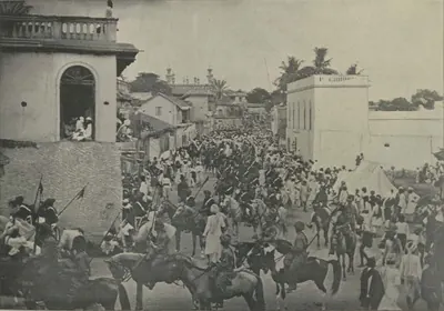 Horsemen riding in a crowded street procession.
