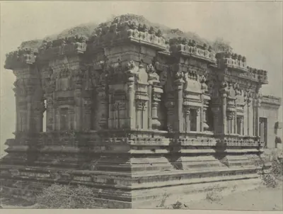 A Hindu temple with richly carved walls and a carved roof parapet, on a moulded plinth.
