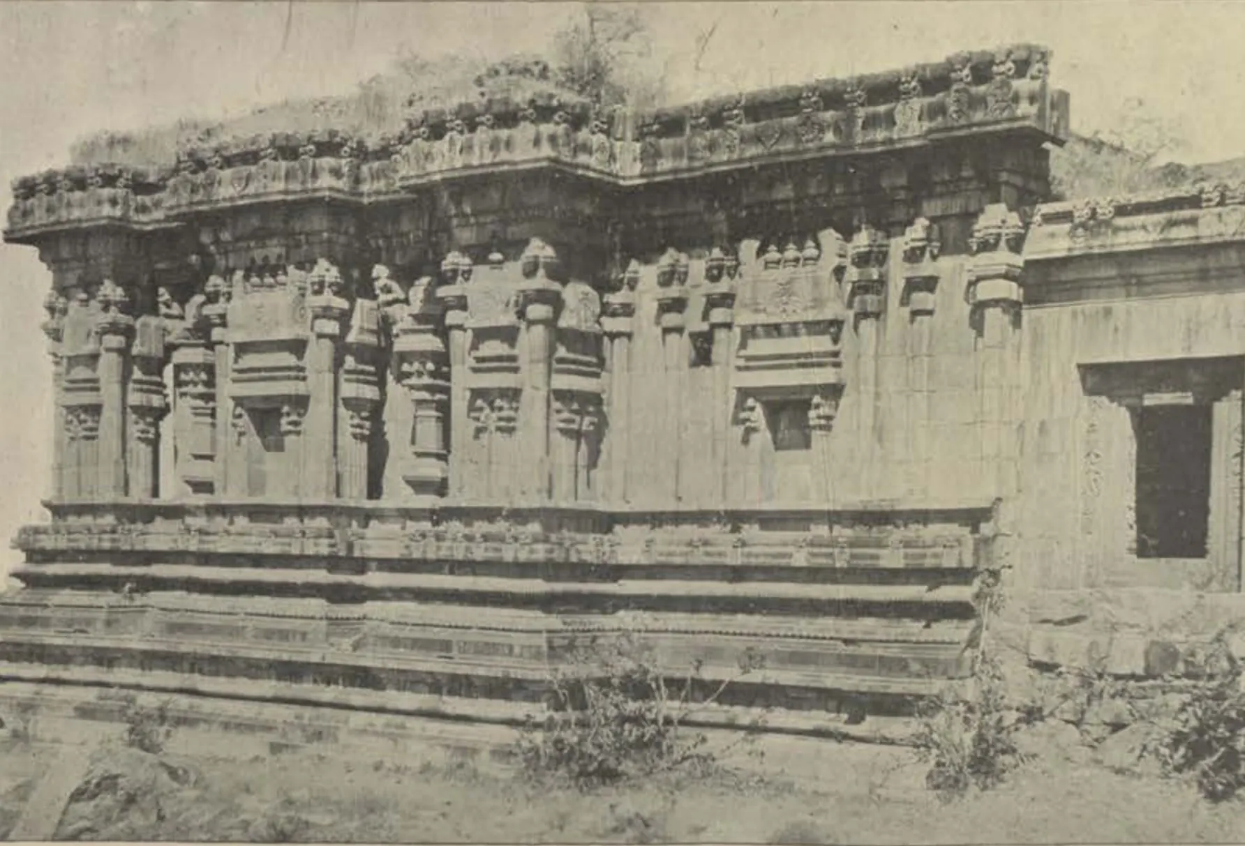 Another view of the same carved Hindu temple, its walls and moulded plinth.